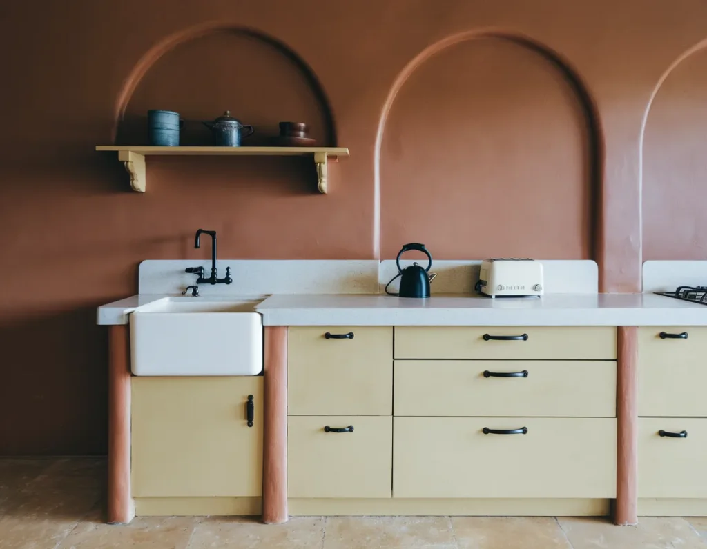 Accent terracotta wall in kitchen with balanced lighting