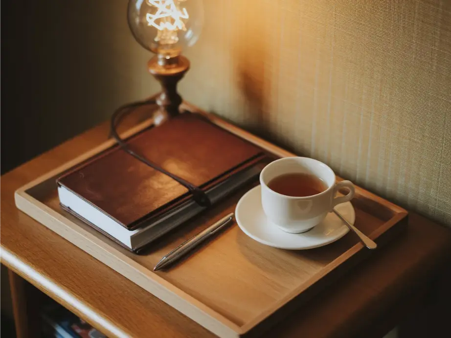 Dorm bedside table with small tray holding