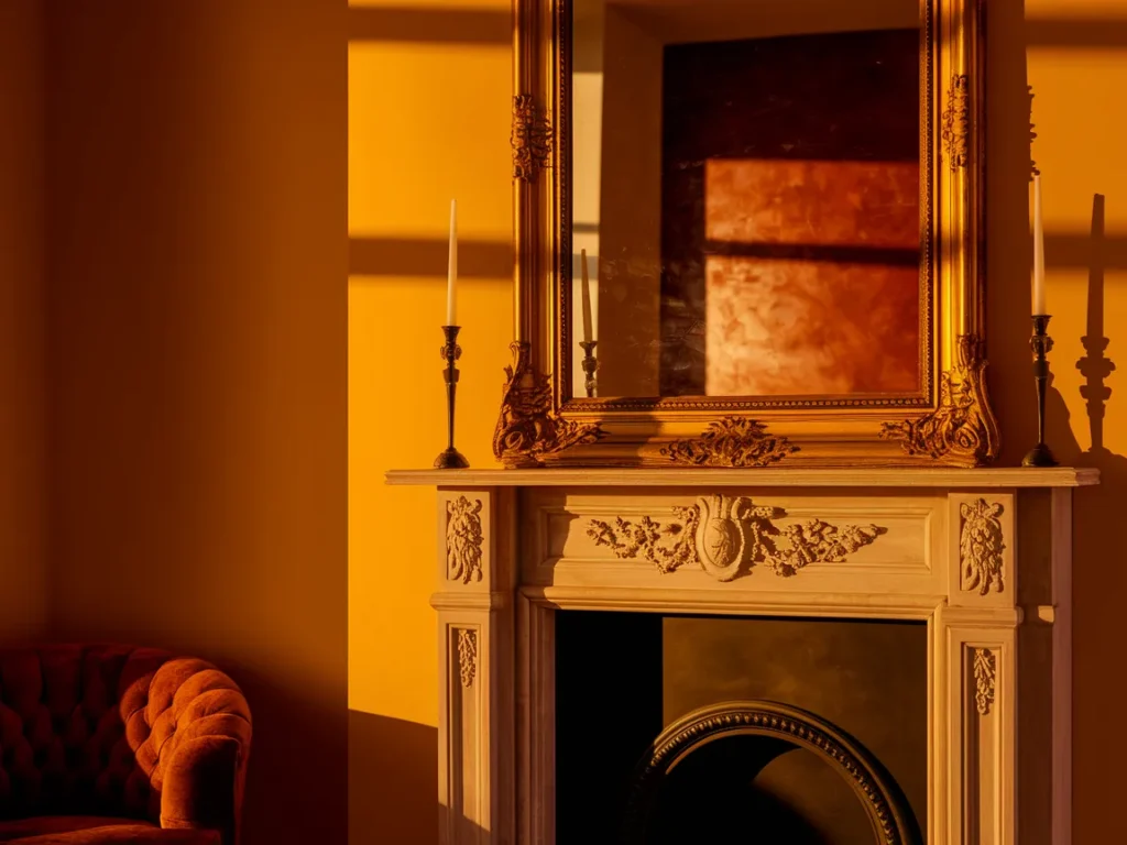  Fireplace mantel with large framed mirror above