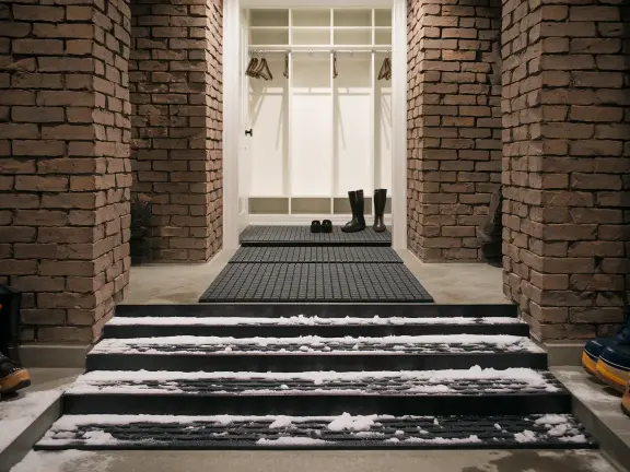 Winter mudroom entry with layered mats trapping