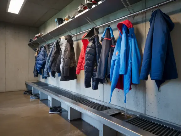 Winter mudroom with drying hooks holding wet coats
