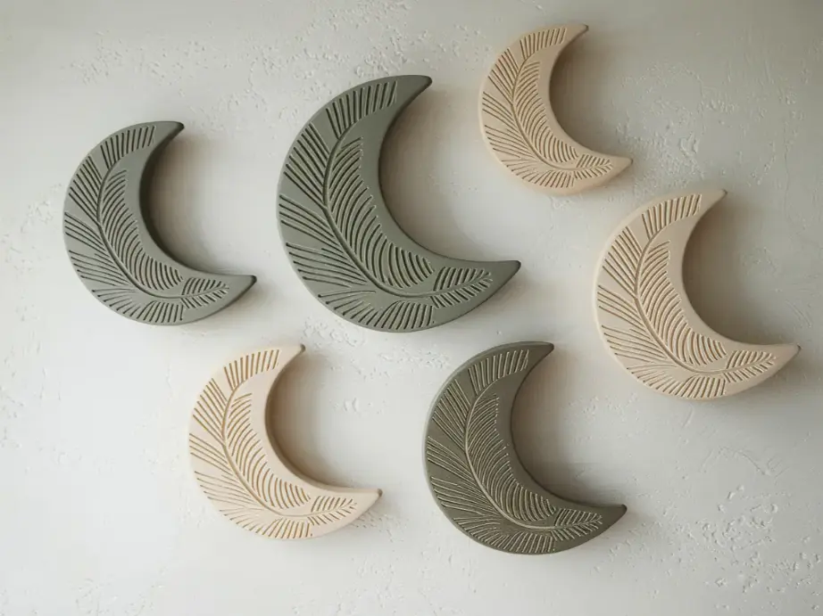 set of five handmade ceramic wall hangings in various organic crescent