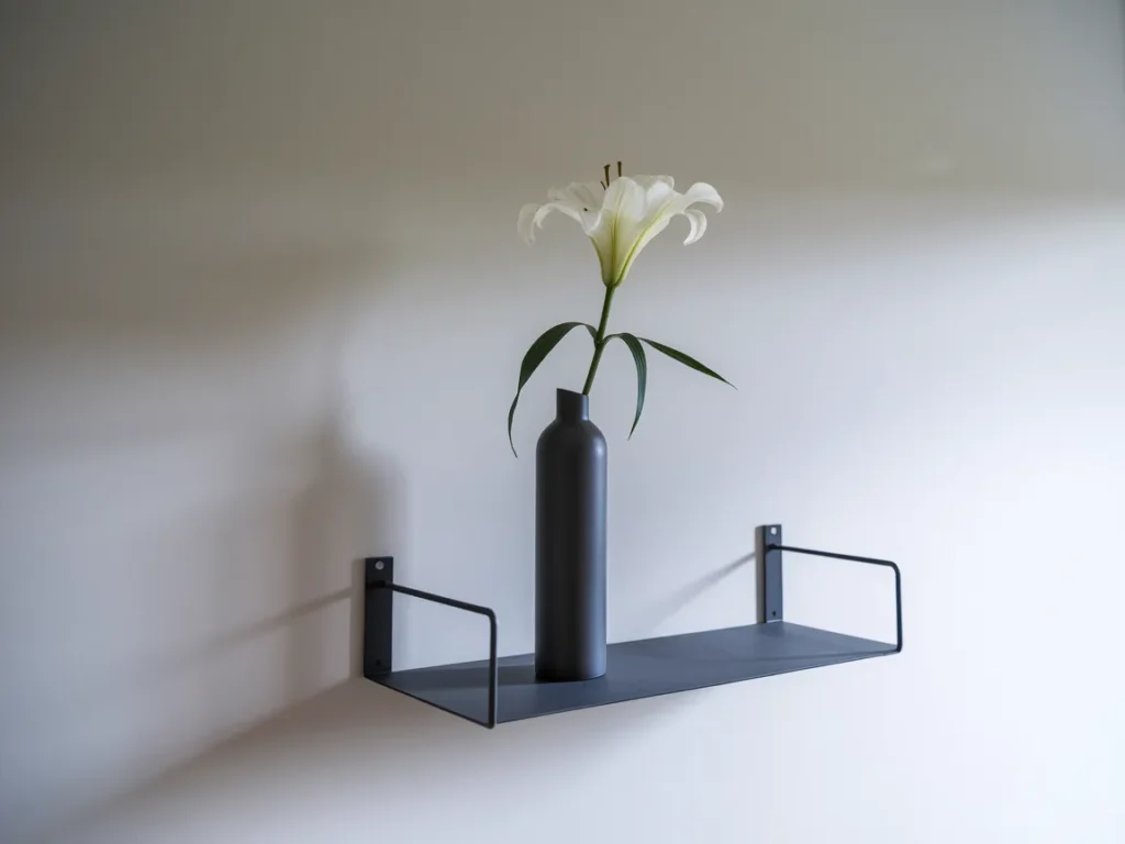 single white lily in a tall slim matte black vase